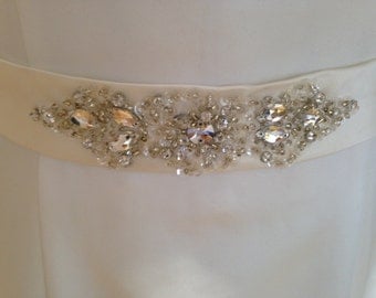 An ivory wedding dress belt beaded on duchesse satin material for a bride crystal beads vintage look