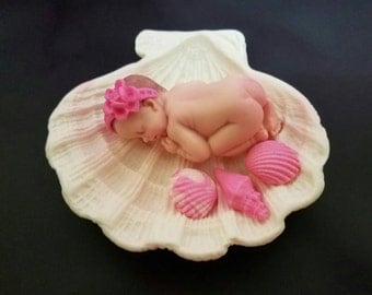 Fondant baby laying on a Clam Sea shell cake topper for Baby Shower, Birthday, Party Favor