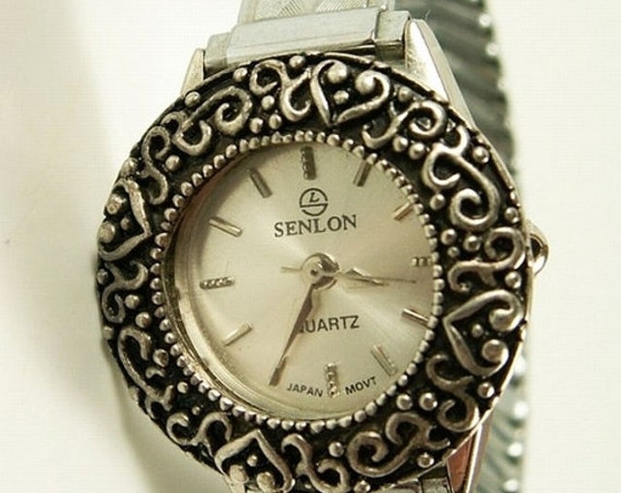 Storewide 25% Off SALE Lovely Vintage Senlon silver tone quartz watch with lace styled decorative bezel trim and an adjustable stretch band