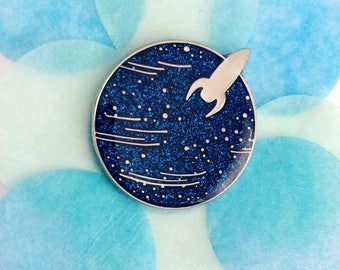 Little Planet enamel pin - sparkly blue glitter planet with rocket landing. Cute science pin, blue planet geeky pin