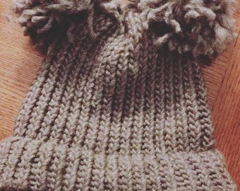 Knitted hat with puffs