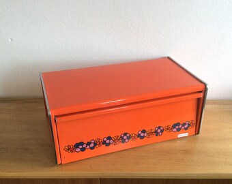 Seventies orange Brabantia Diana square shouldered bread box with floral motif and chrome trim. Retro bread box.