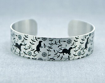 Otter jewellery cuff bracelet, brushed silver with black otters. Recycled jewellery. Otter gifts, wildlife animals. Secret message. B480