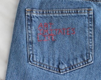 embroidered jeans, "art imitates life, life imitates art", upcycled hand embroidered women's jeans art quote