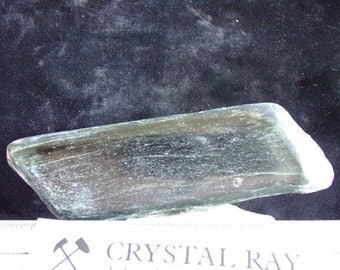 A Tremolite end cut that has been polished on one side