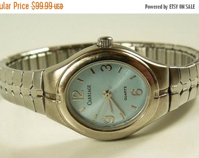 Storewide 25% Off SALE Vintage Ladies Silver Tone Carriage By Timex Quartz Designer Watch Featuring Metallic Blue Face With Expandable Band