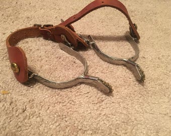Vintage riding spurs with leather straps