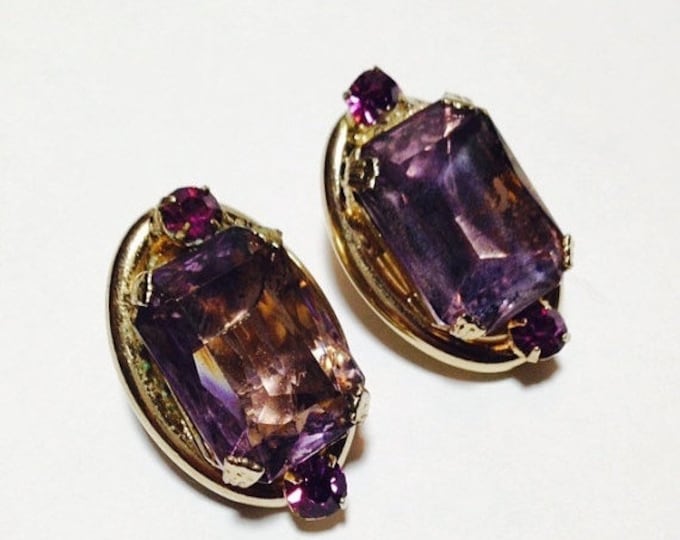 Storewide 25% Off SALE Vintage Gold Tone Oversized Amethyst Purple Rhinestone Designer Clip Earrings Featuring Emerald Cut Design