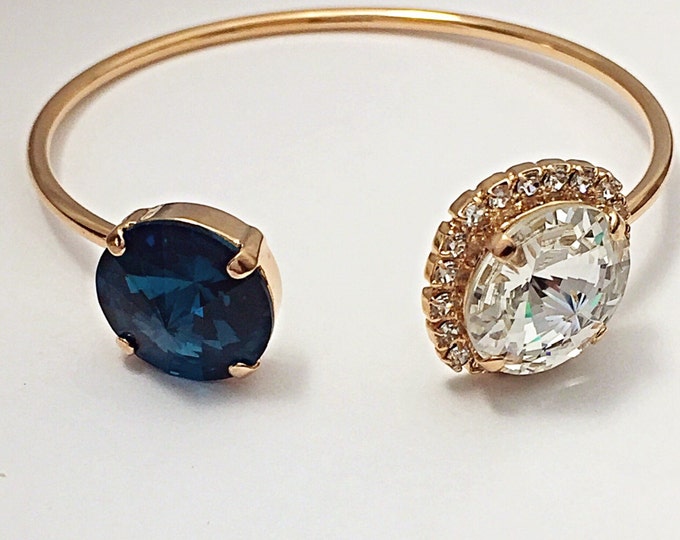 Swarovski® crystal open cuff bangle Rose gold embelished with montana blue and white Swarovski crystals. Sapphire blue color