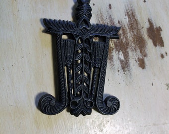 Vintage Small Cast Iron Trivet With Brooms