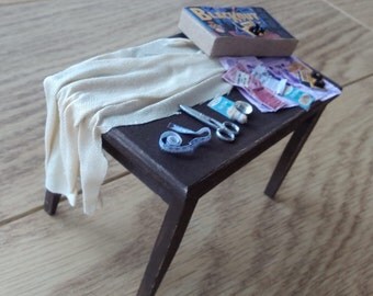 Distressed and battered kitchen table in the middle of making blackout curtains
