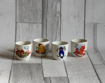 Four Vintage Children's Egg Cups with Animal Decoration