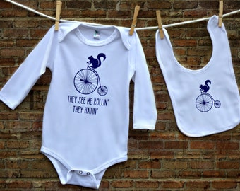 They See Me Rollin' They Hatin' Squirrel on Bike Baby Bodysuit and Bib