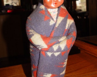 Wonderful vintage old "Skookum" Native American Indian Doll with side-glancing eyes and blanket wrap