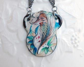 Three small painted pendants on multiple chains, necklace in blue, teal, green, brown, cream and touches of rose.
