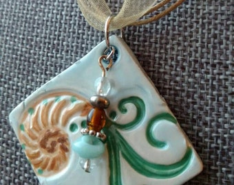 Nautilus scroll with seaside pendant