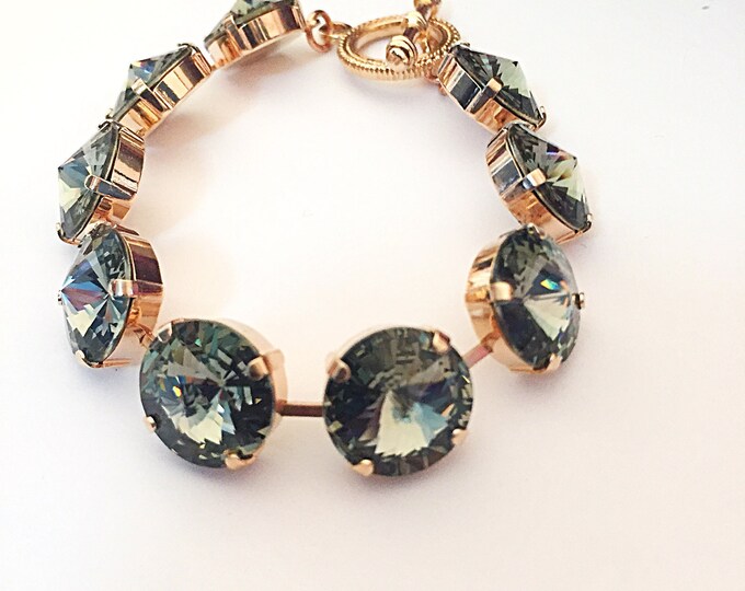 Alluring timeless fashion forward Swarovski crystal black diamond rivoli tennis bracelet that embodies elegance .