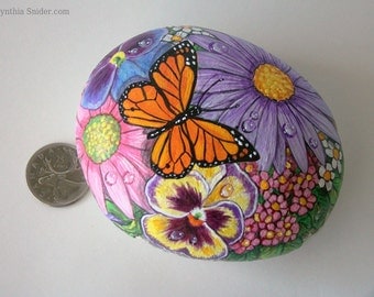Painted rock,painted stone,flower rock,painted floral rock,monarch butterfly,pansy,gerbera daisy,purple flower,flower basket,garden decor