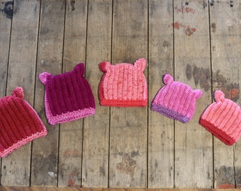 Pink pussyhats in a variety of sizes