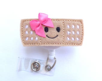 Badge Reel Retractable - Stick it - Smiley face pink bow - tan felt band aid - Nurse badge reel school nurse pediatrician medical badge reel