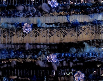 Textile art, Long woven wall hanging blue "Blue Cascade" sewn with 10 small blue fabric roses