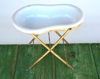 White enamelware bidet on metal stand