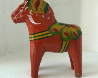 Small Swedish wooden Dala Horse painted red with traditional 'kurbits' decorative detail
