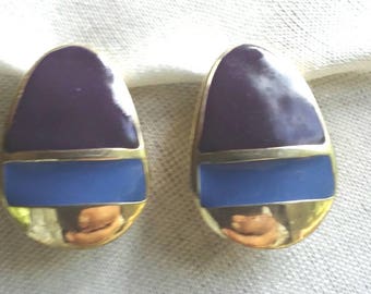 Vintage signed Original by Robert Purple, Blue enamel on gold tone metal curved disc. Clip on earrings