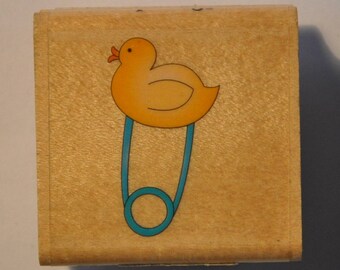 Rubber stamp mounted on wood - birth - duck safety pin