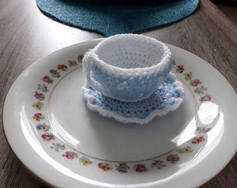 Cup and saucer with hand made crochet