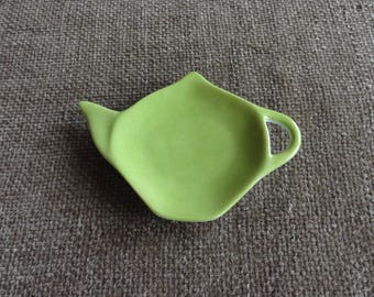 Is white porcelain Teacup handpainted lime green.