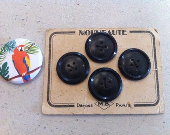 Old plate of 4 black buttons