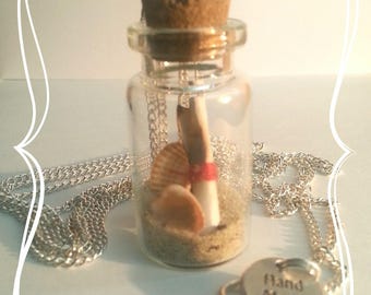 Scroll in his bottle of sand and shells necklace