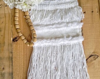 Hand woven wall hanging in white