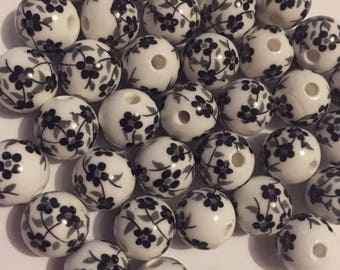 Set of 10 handmade porcelain 12mm black and white flower beads.