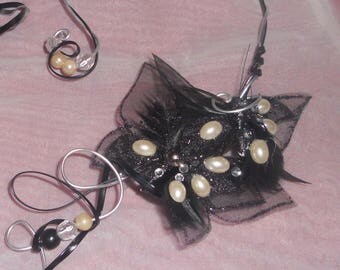 "Moth" necklace with black and white beads.