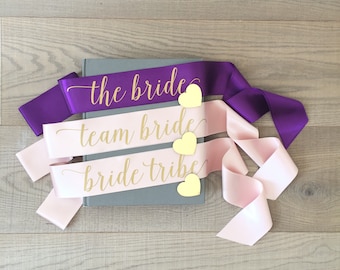 The bride sash, team bride sash, bride tribe sash, bachelorette sash with gold heart pin, hen sash, hen party sash, bridal sash