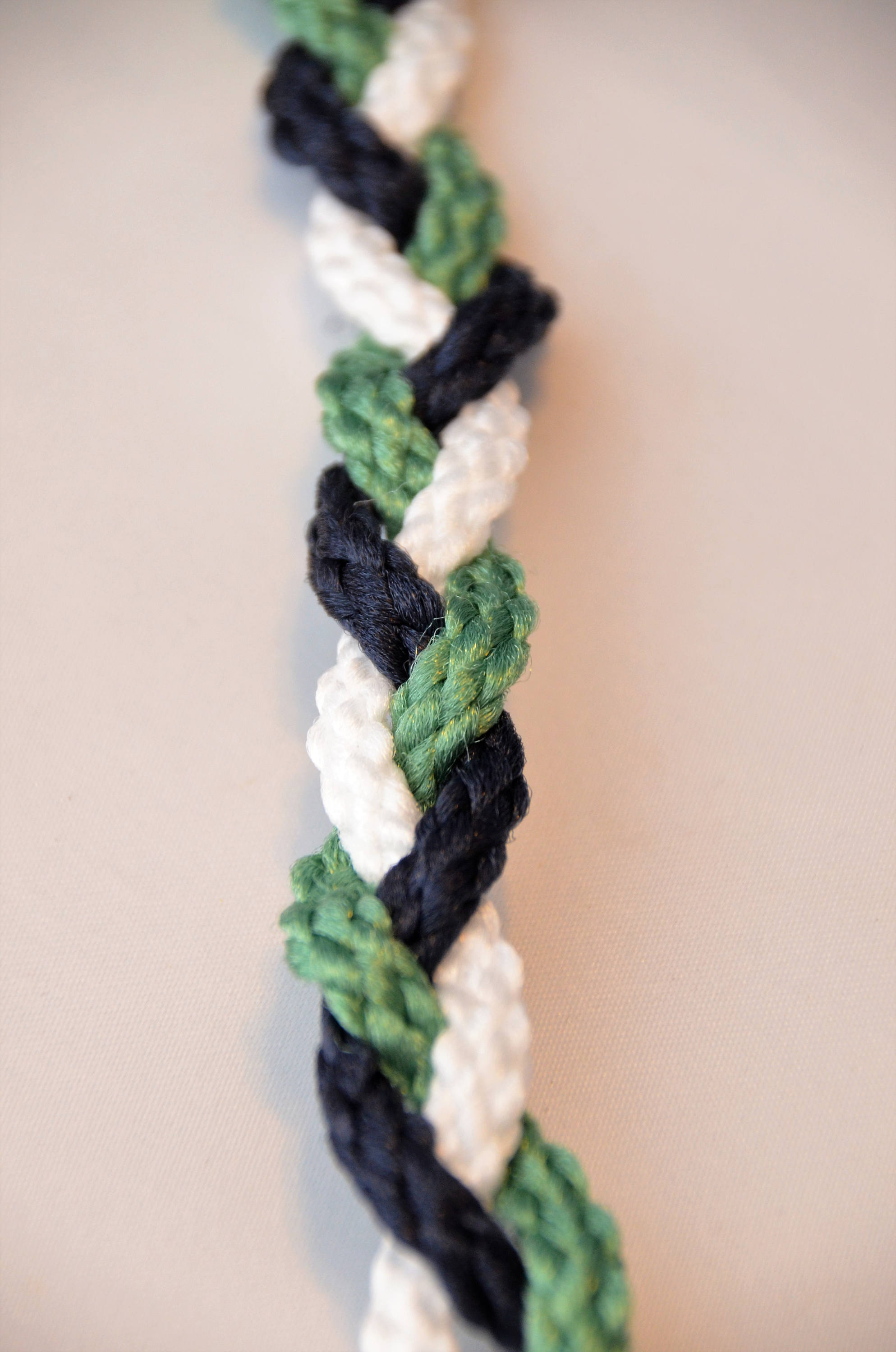 A Cord of Three Strands Divinity Braided Cord with Bow