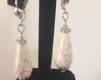 Ivory colored glass bead with brown enhancement