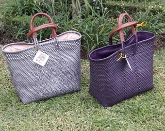 Of plastic woven bag with lining and leather handles
