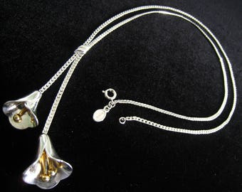 AVON Calla Lily Lariat Look Necklace circa 1978. Silver Tone Metal with Gold Tone Flower Stamens. Neck Strand is 21". Lariat Pendant 3"