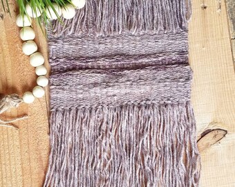 Hand woven wall hanging in brown