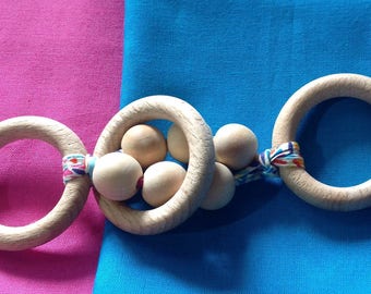 Wooden rattle and teether in her pouch.