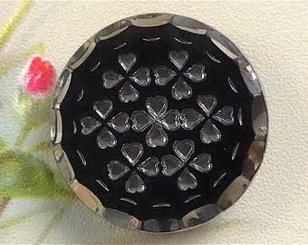 Parti-lustre glass button, antique. Black glass with silver lustre & a floral design, 4 hole sew thru. c1900-1910.