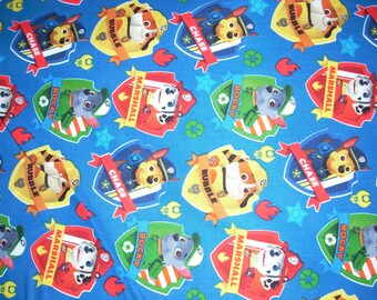 Paw Patrol Patches on blue - Cotton Fabric - 44 inches wide and sold by the yard