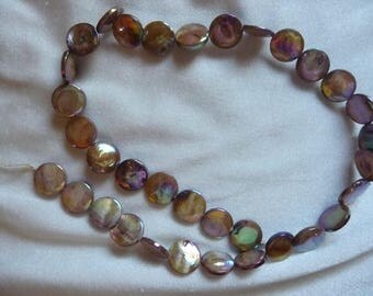 Beads, Mother of Pearl, 10mm Flat Round Coin , Shades of Gold, Very Shiny. Sold per 15 inch strand. Total of 34 beads on strand.