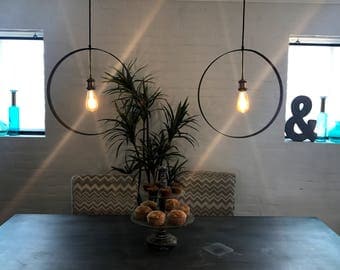 Black steel ring pendant light with brass accents and included LED blub.