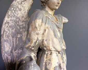 Antique statue of an Angel plaster with child.