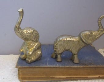 2 Brass Elephant Ornaments or Paperweights 1 sitting and 1 standing Lucky trunks