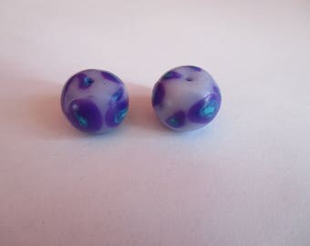 2 beads made of polymer clay and varnished